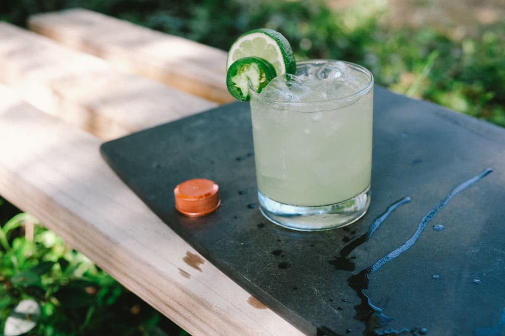 Tito's Handmade Vodka cocktail with jalapeño and lime slice