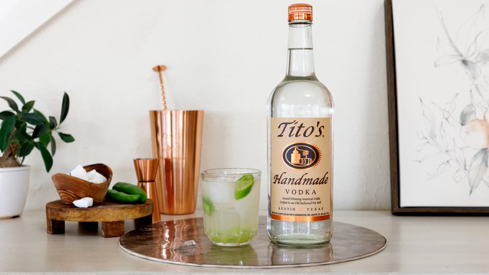 Tito's Smash in a rocks glass with a Tito's Handmade Vodka bottle