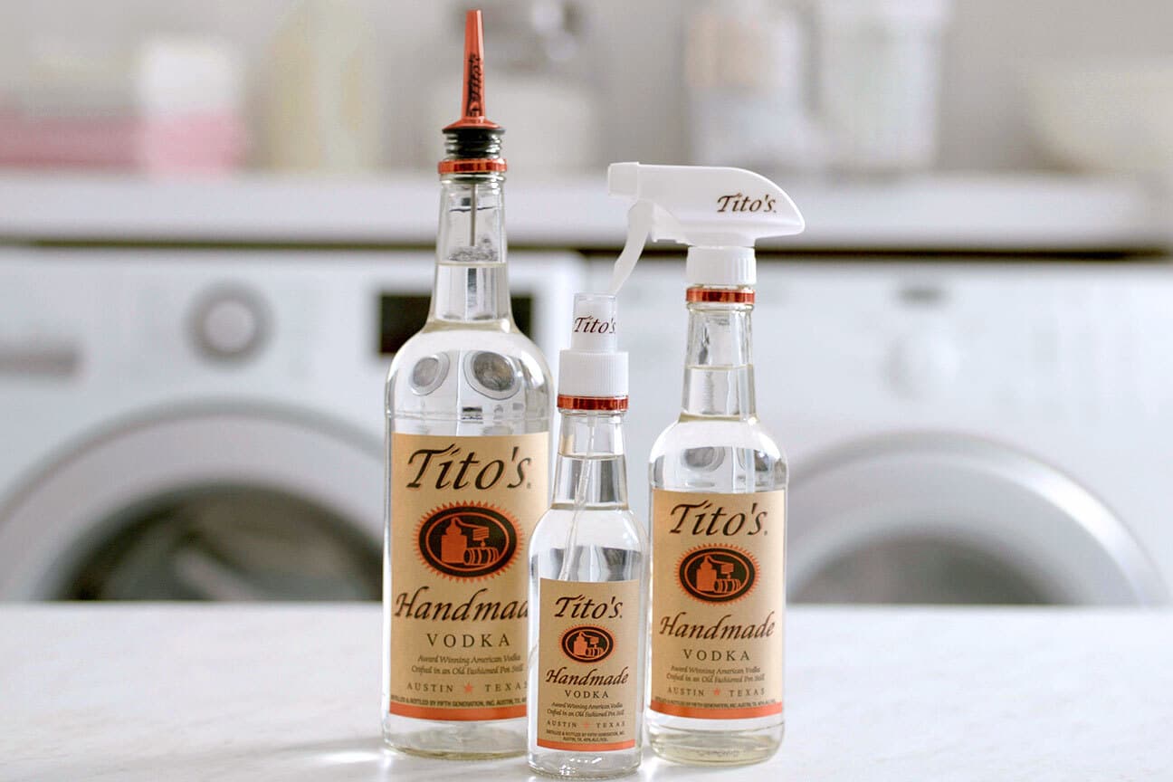 Three Tito's Handmade Vodka bottles with pour spot, spray nozzle, and mister