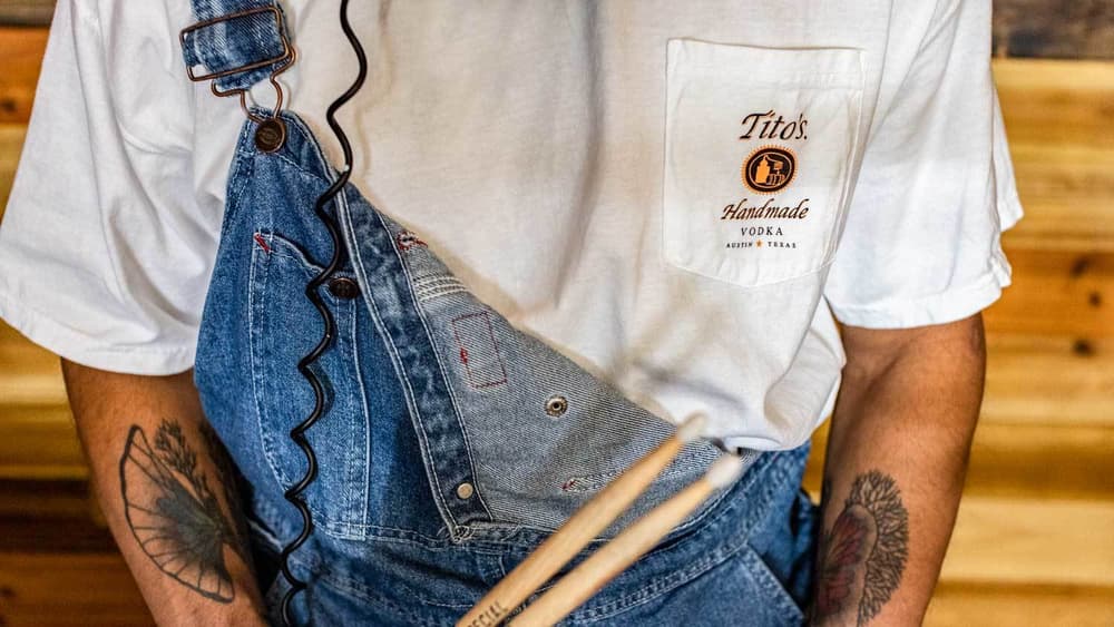 Drummer wearing white Tito's Taster Tee