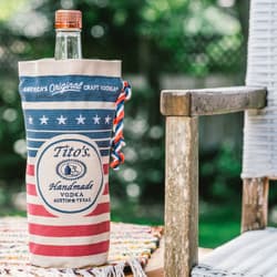 Tito's Vodka bottle inside a Tito's red, white, and blue bottle bag