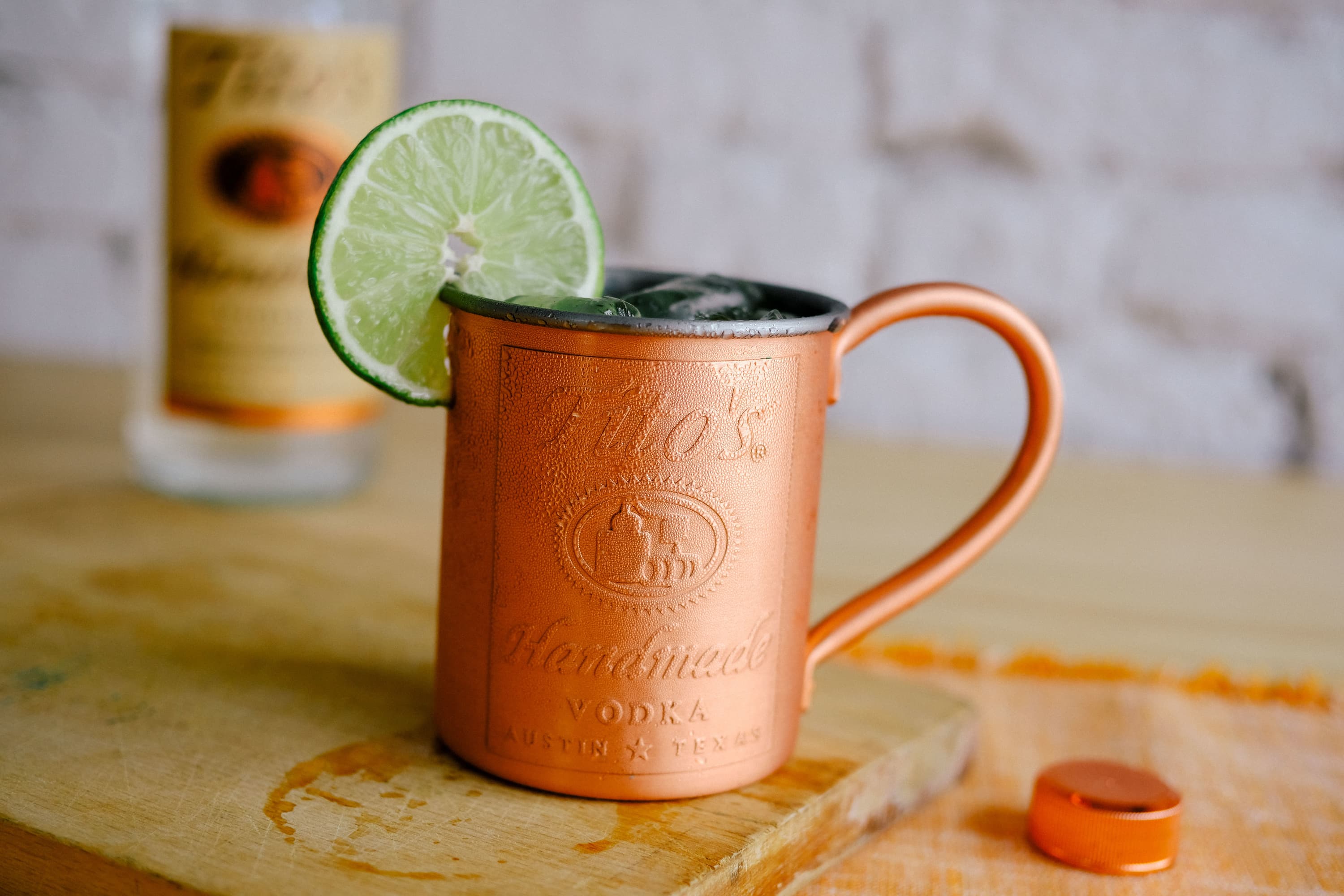 Cocktails in a Tito's Copper Mug garnished with a lime slice