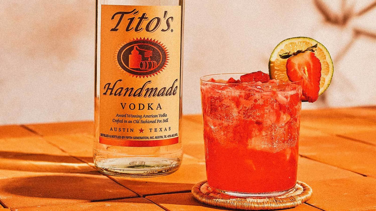 Tito's Agua Fresca garnished with a lime and strawberry