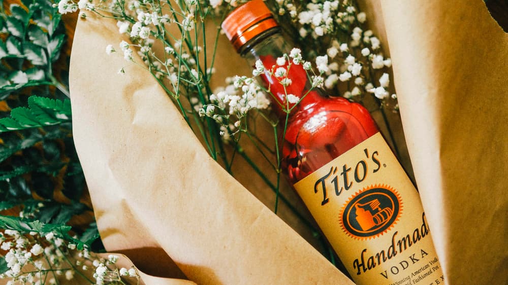 Tito's Vodka bottle filled with rose petals