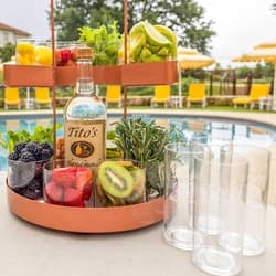 Tito's Garnish Caddy and ice bucket by a pool