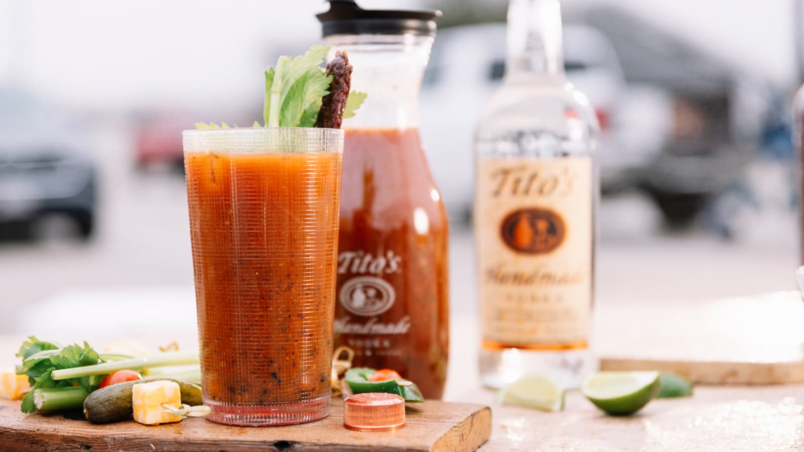 Tito's Warm-Up in a pint glass with a Tito's Handmade Vodka bottle and carafe