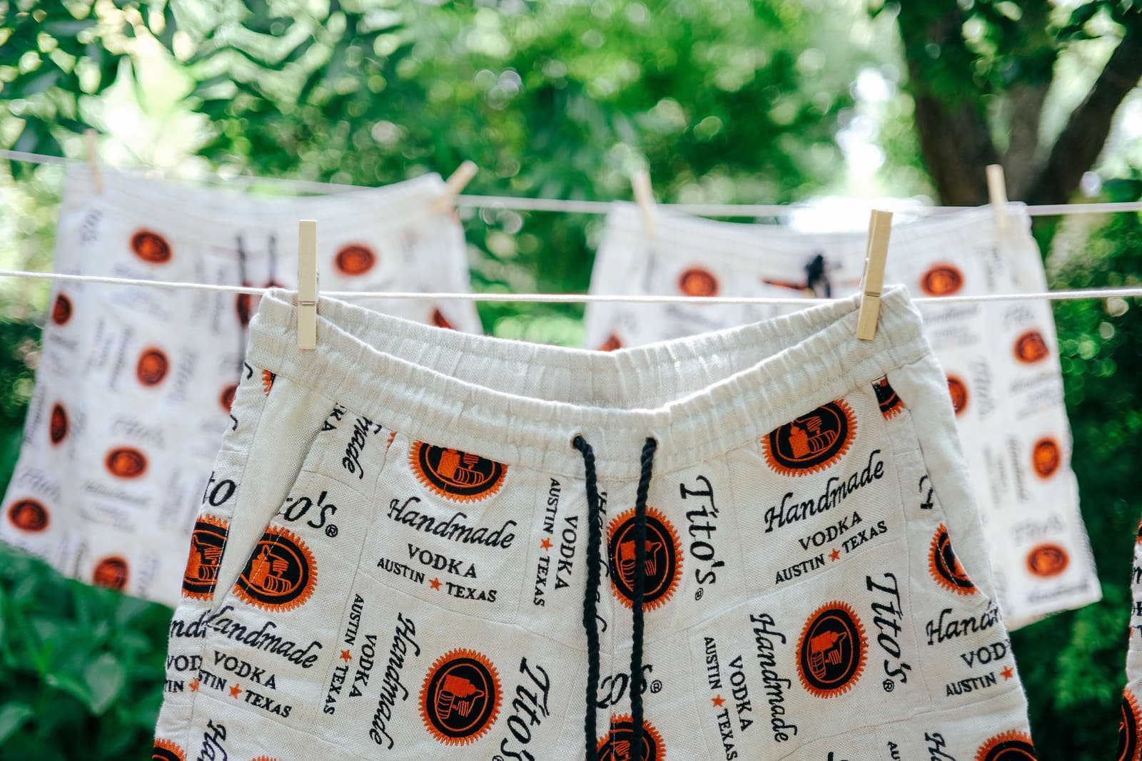 Tito's logo branded shorts hanging on a clothesline