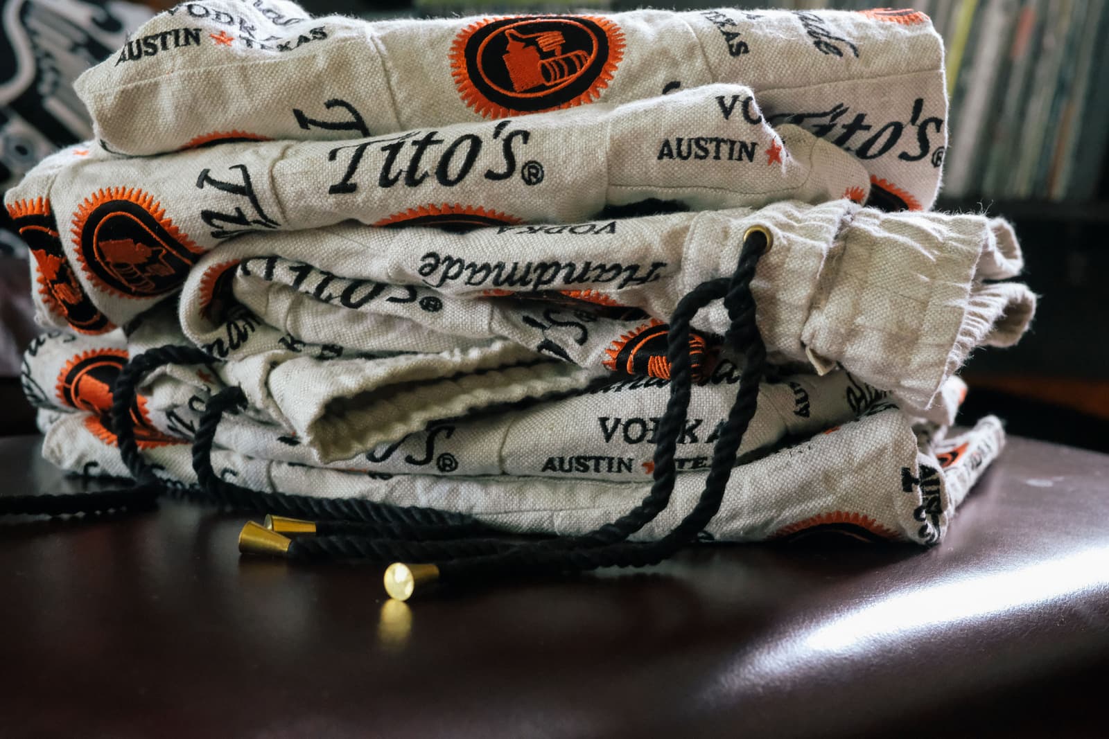 Tito's Vodka logo branded shorts in a pile on a table