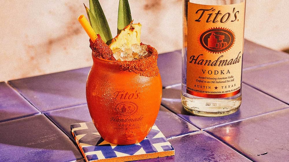 Tito's Cantarito garnished with a pineapple and chile-lime salt