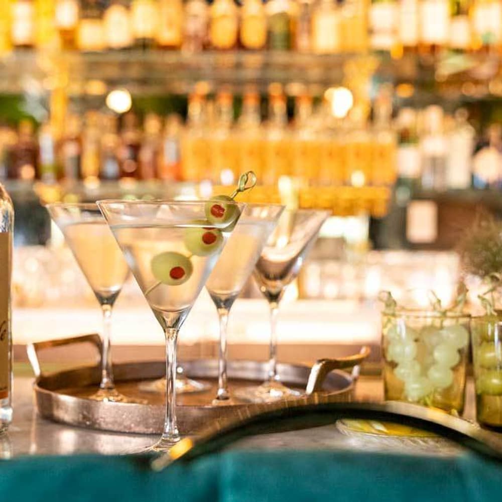 TIto's Handmade Vodka bottle with martinis and olives