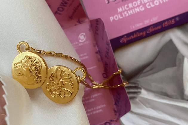 Gold-plated jewellery by Michaela Lyons Jewellery, with a Town Talk microfibre polishing cloth