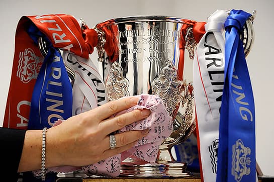 Carling Cup being cleaned with a Town Talk polishing cloth