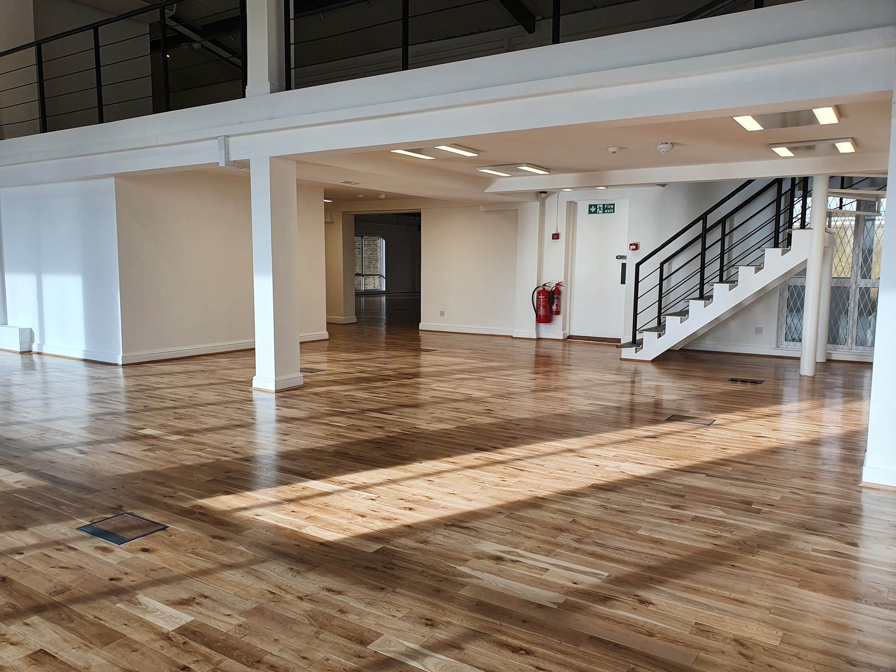 Totally clear empty office space with wood floor and mezzanine