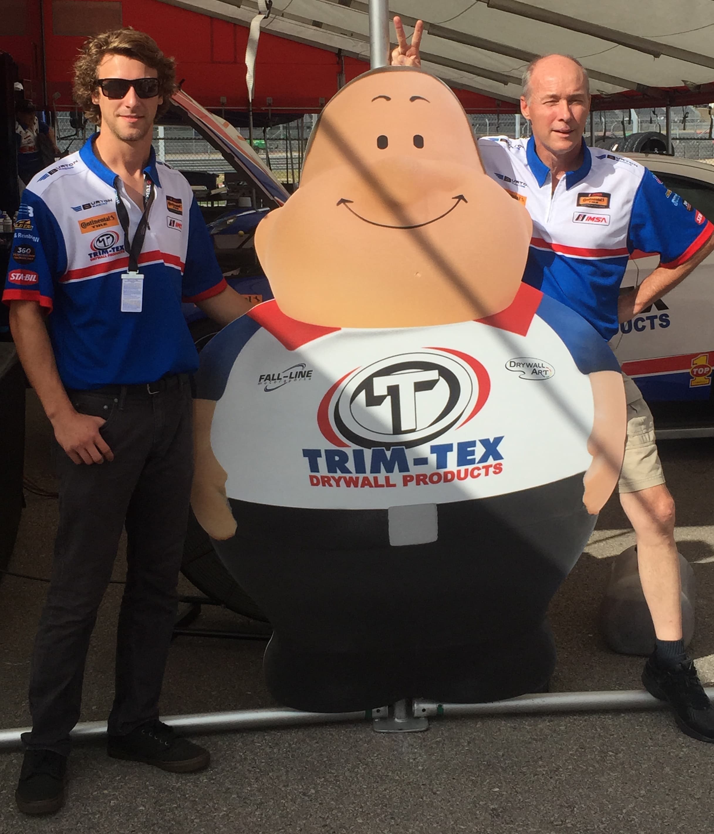 Trim-Tex Owner and Josh Bilicki pose with Drywall Arty before the COTA race.