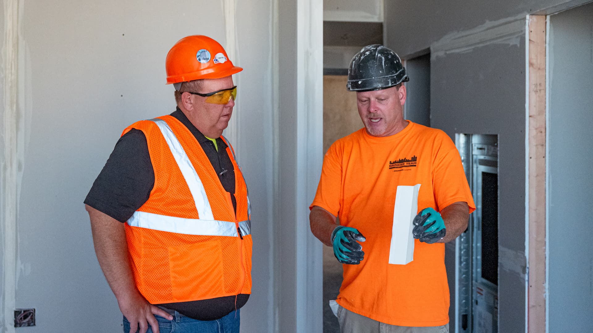 A Trim-Tex sales rep speaks with a contractor about a rolled corner bead
