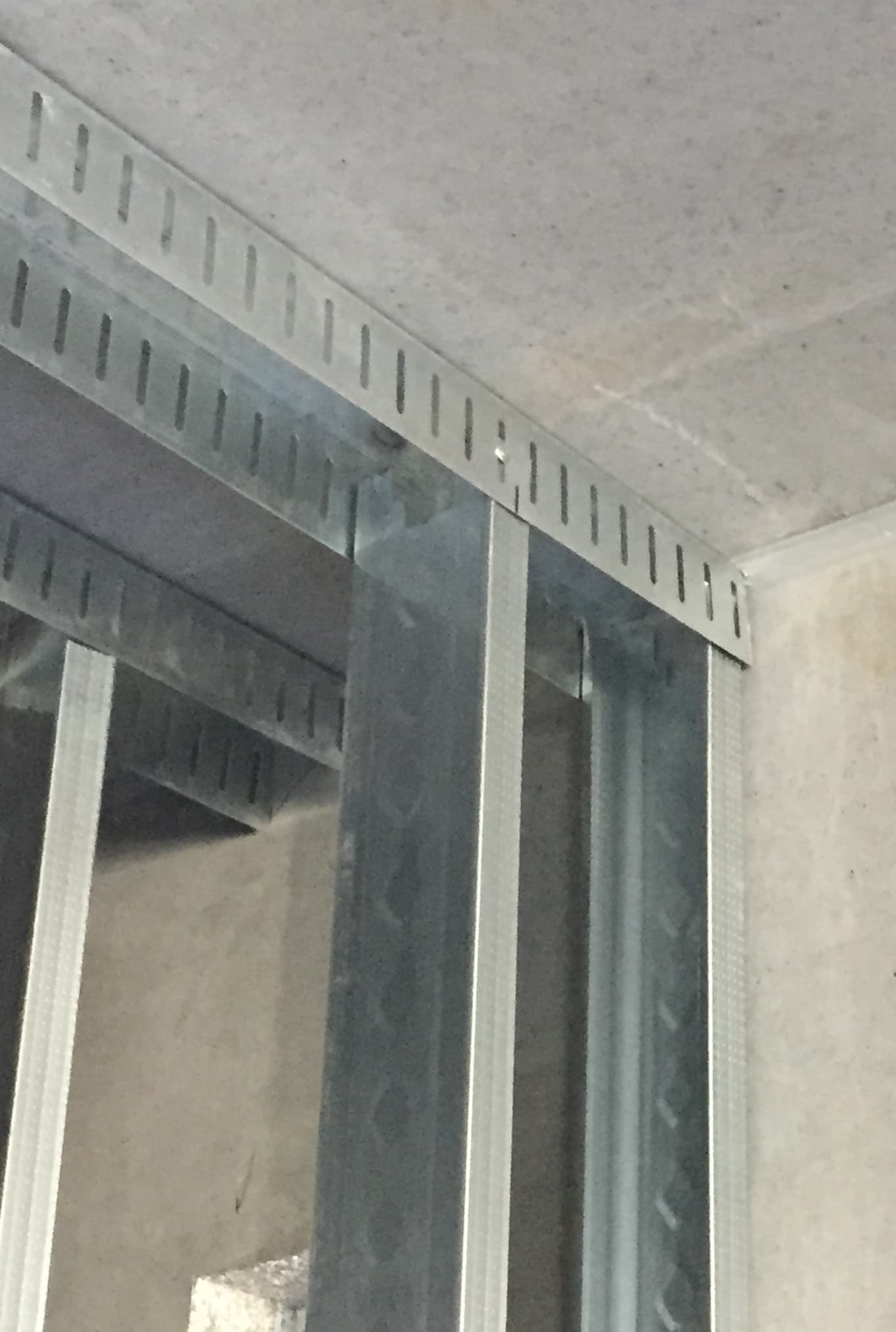 To prevent deflection pressure from damaging the walls, the top track of the wall is slotted so it can move up and down on the studs. To prevent deflection pressure from damaging the walls, the top track of the wall is slotted so it can move up and down on the studs.