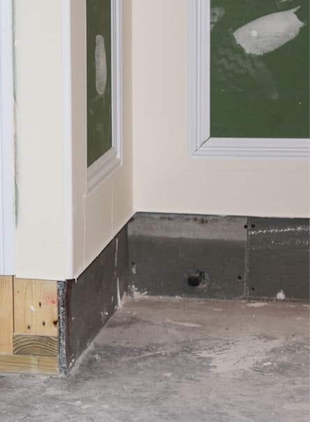 Cement board protects basement drywall from minor flooding. Cement board protects basement drywall from minor flooding.