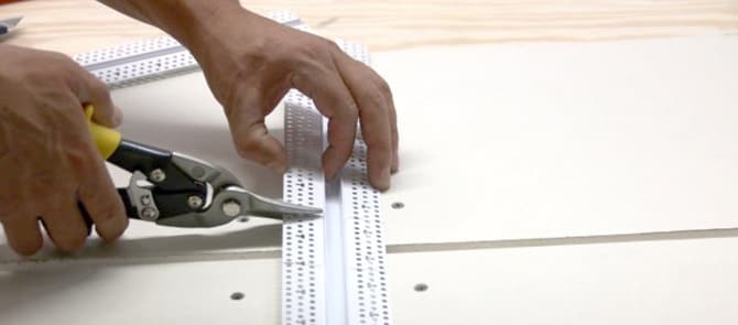 Using snips, cut along the markings that were made with the speed square.