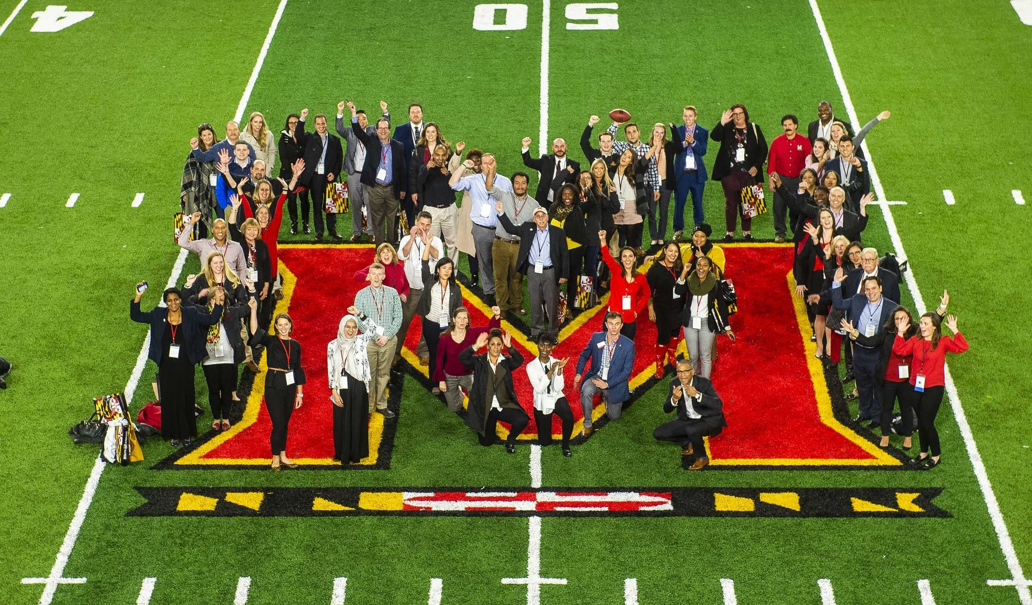 People standing on the Maryland logo