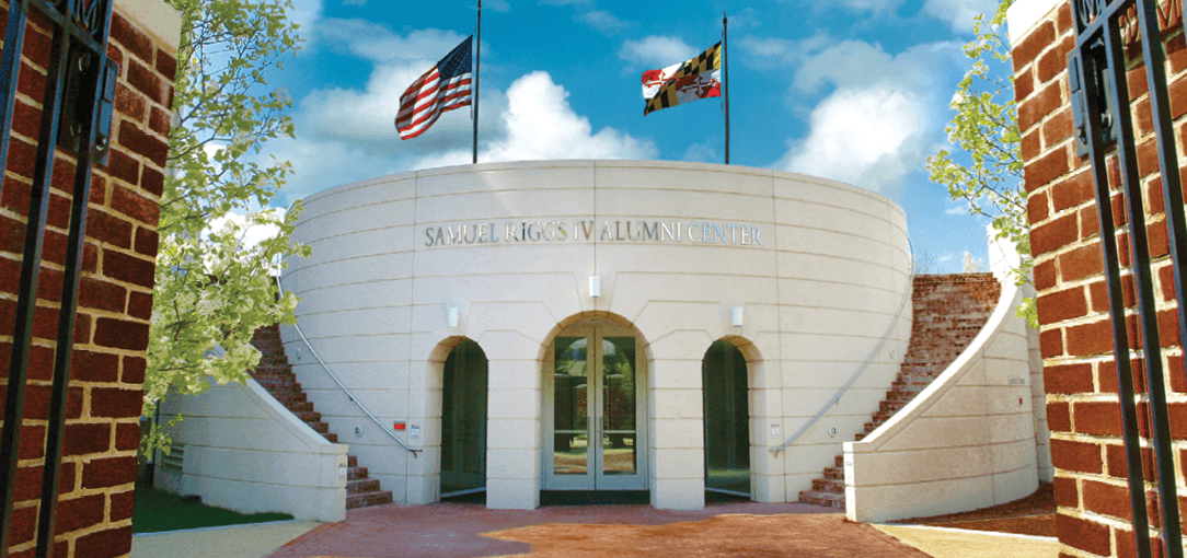View of Front of Riggs Alumni Center from the gates of Moxley Gardens.
