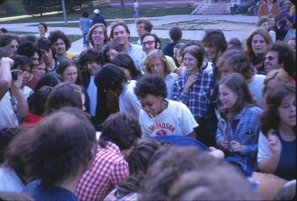 A group of students participating in and watching the Complex Olympics Pie Eating Contest in 1975