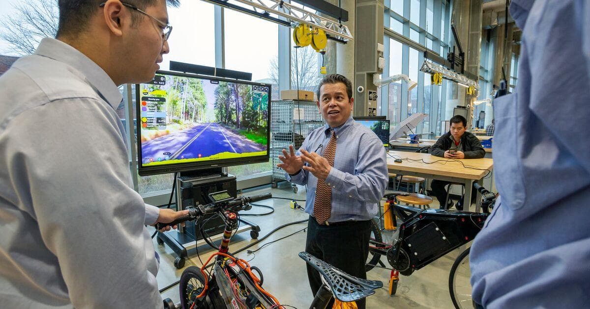 Professor of Electrical and Computer Engineering Romel Gomez works with students for the E–Bike MPact Challenge in the A. James Clark Building’s Leidos Hall
