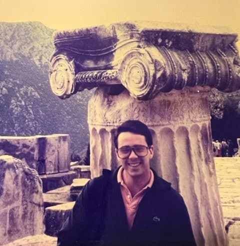 Marshall Fitzgerald standing next to an ancient column during his trip to Italy and Greece.