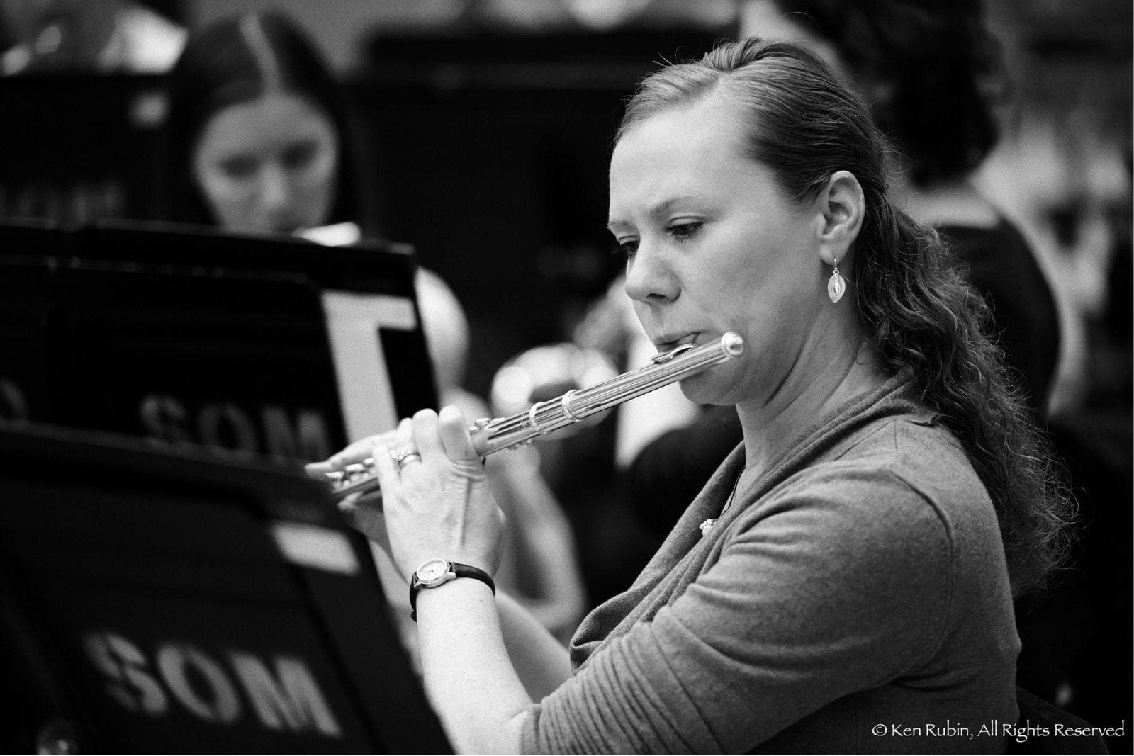 A woman plays the flute.