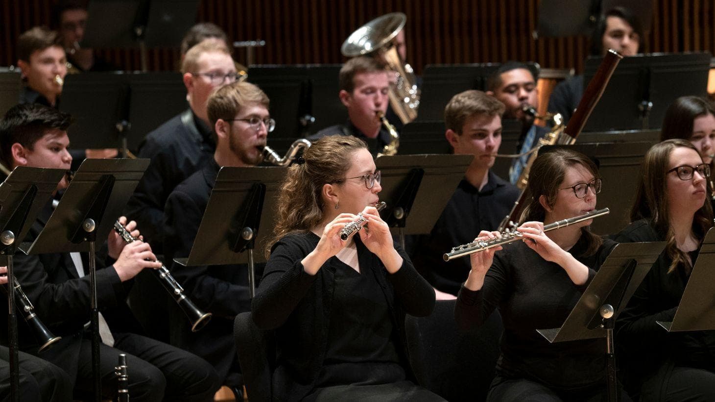 UMD Wind Orchestra students perform on stage.