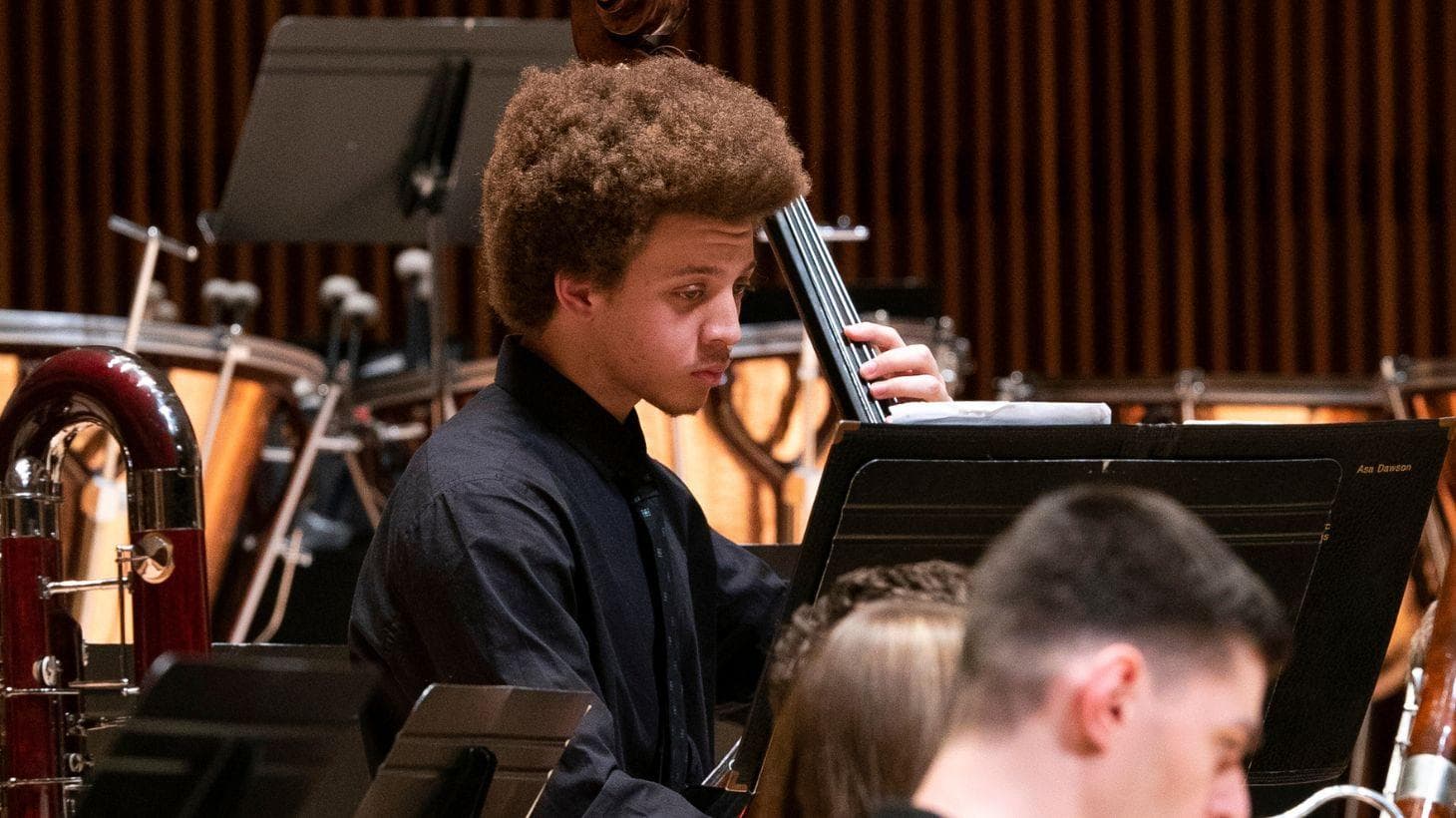 Student plays cello on stage.