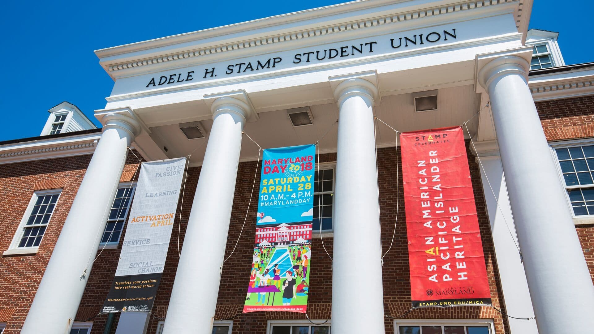 The front entrance to the Stamp Student Union with Maryland Day banners hanging from the columns