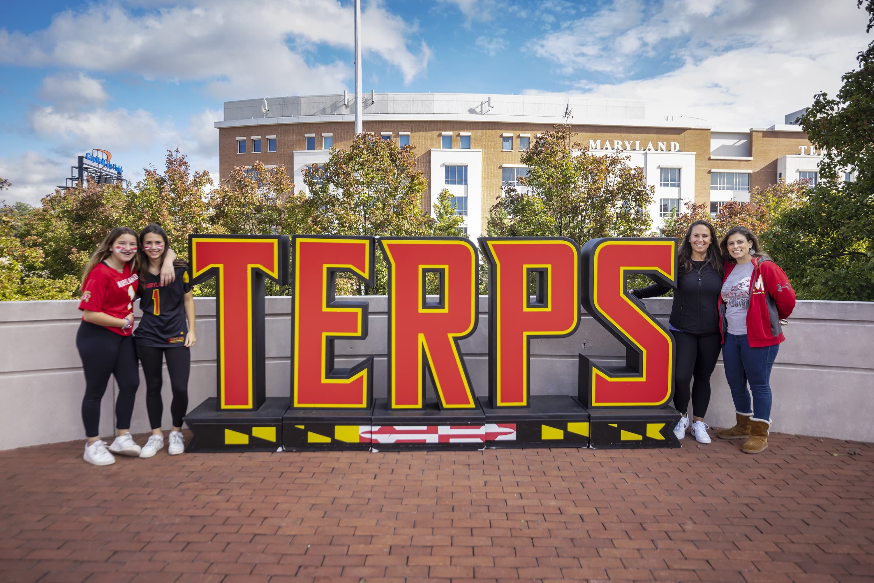Students standing in front of oversized sign that says TERPS