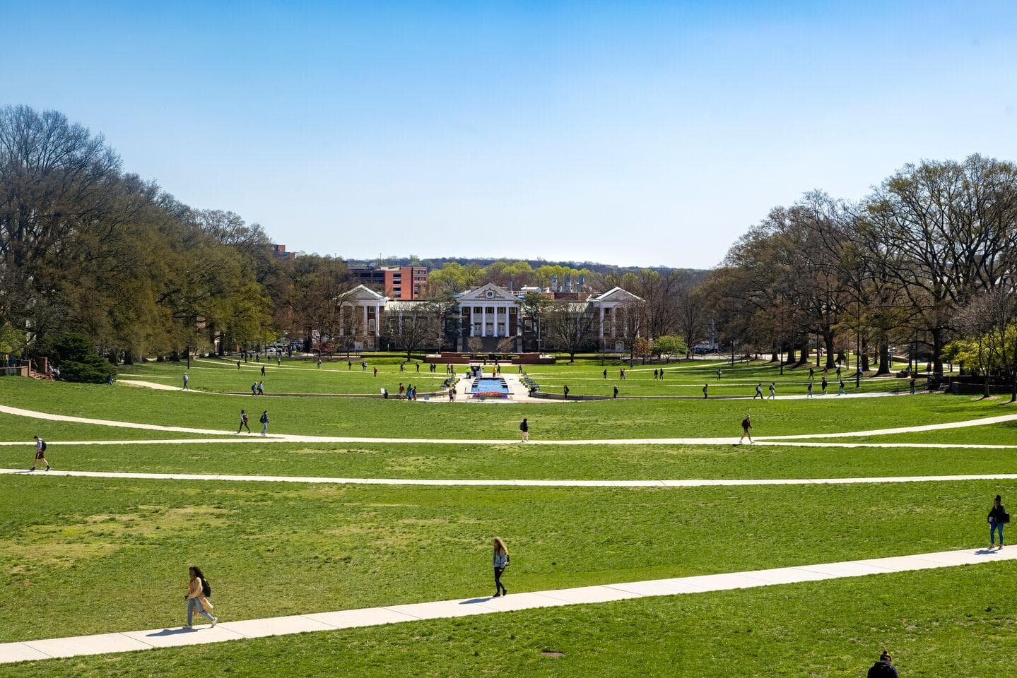 Students walking on the sidewalks that cross McKeldin Mall