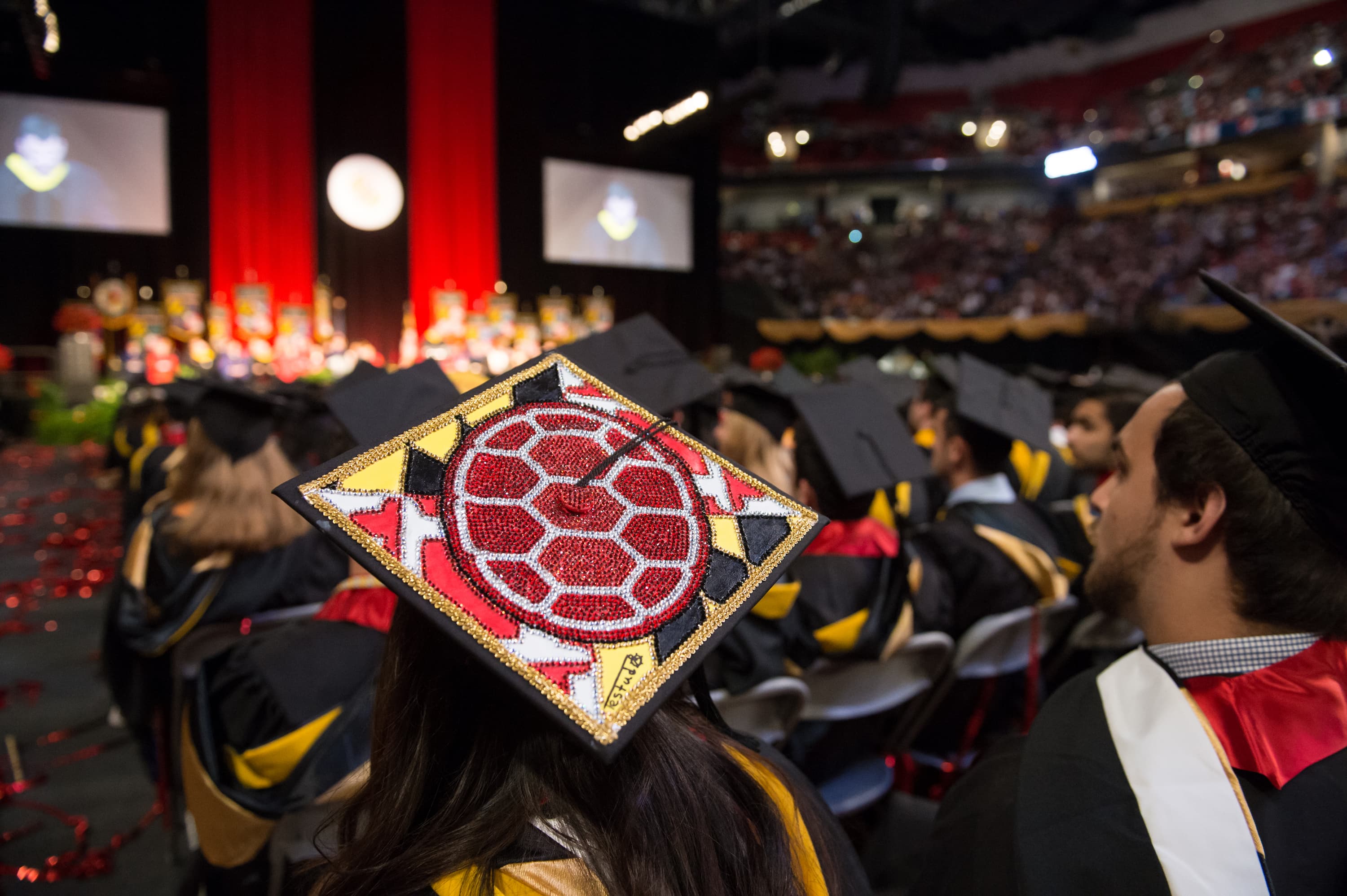 Student with Maryland-themed grad cap at commencement