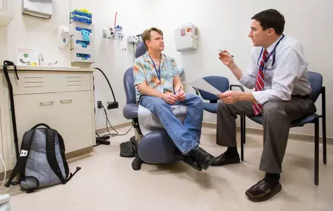 Dorland talks about his leg and foot pain with Dr. Christopher Heery,