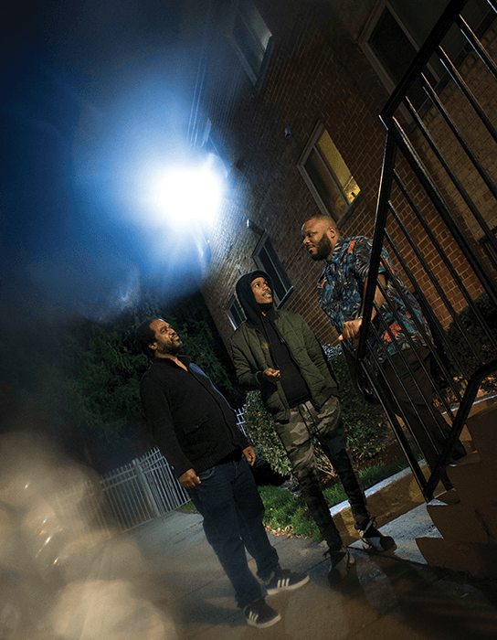 Richardson, left, talks with Chris Edge, center, and Che Bullock, a senior violence intervention specialist.