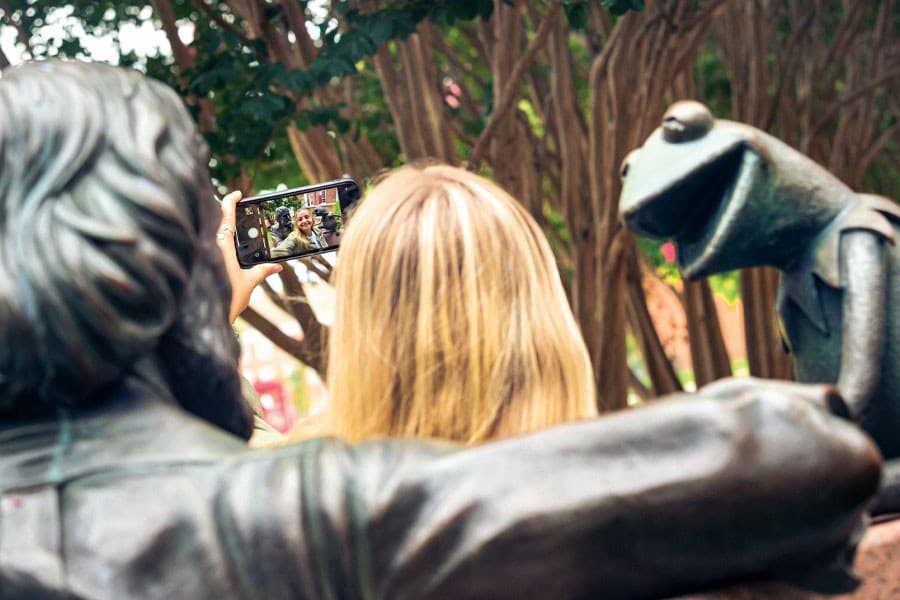 Zoe takes selfie at Jim Henson statue