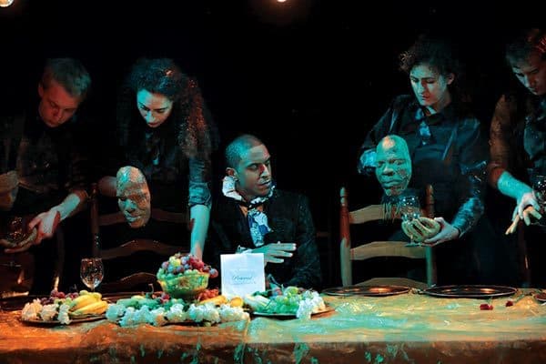 Emmett Till and Amadou Diallo, represented by puppets, at a dinner party