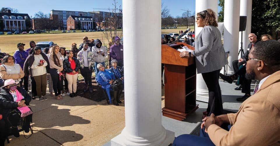 student speaks at podium during Agora dedication