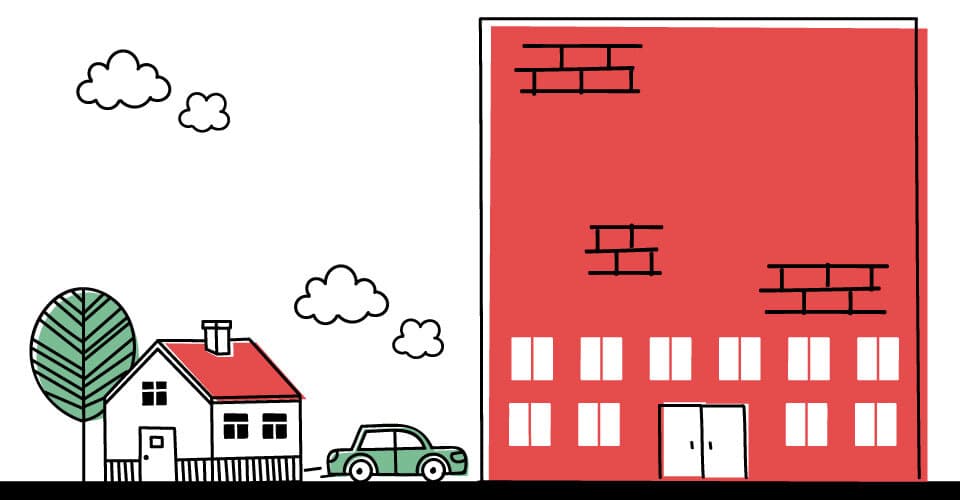 car going from house to brick office building