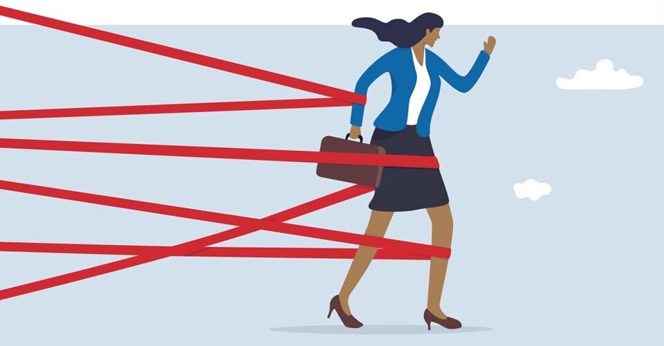 woman with briefcase walking through red tape