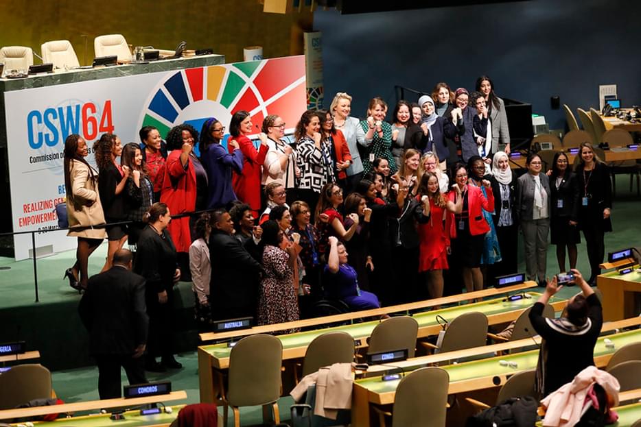 Group photo at the UN Headquarters in front of a CSW64 sign