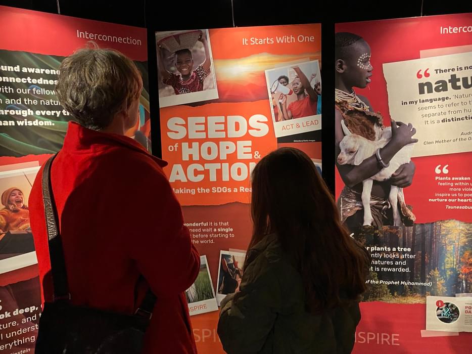 two people looking at the Seeds of Hope and Action exhibition