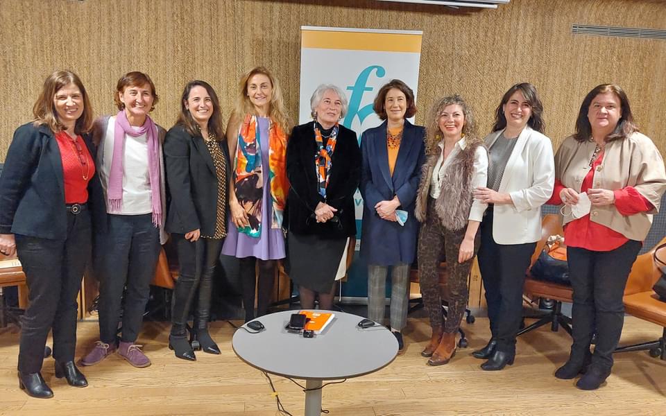 Nine women standing for a group photo at interfaith symposium