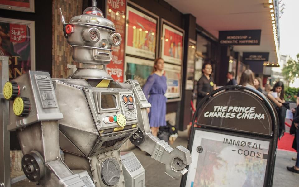 Robot pointing to a sign promoting short film "Immoral Code"