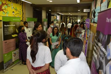 Group of youth viewing exhibition in brightly colored hallway
