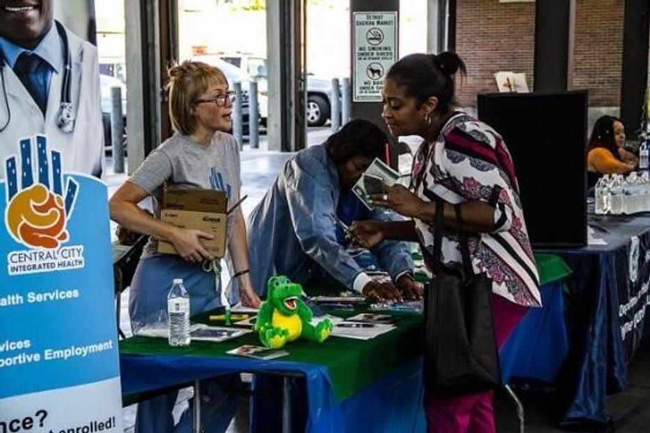 Rachel at a health fair talking with someone