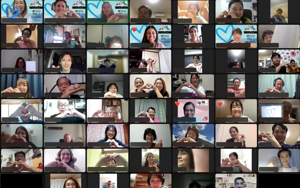 Zoom group photo of 48 people making heart signs with their hands