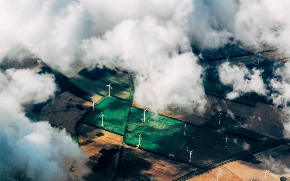 aerial view looking down on clouds and a pasture