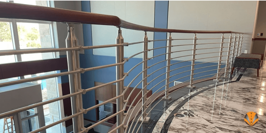 An image of stainless steel railing infills with wood railing.